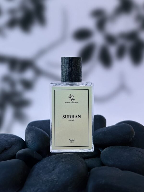 Clear glass bottle of "Surhan for Men" perfume placed on smooth black stones with a blurred leaf-pattern background.