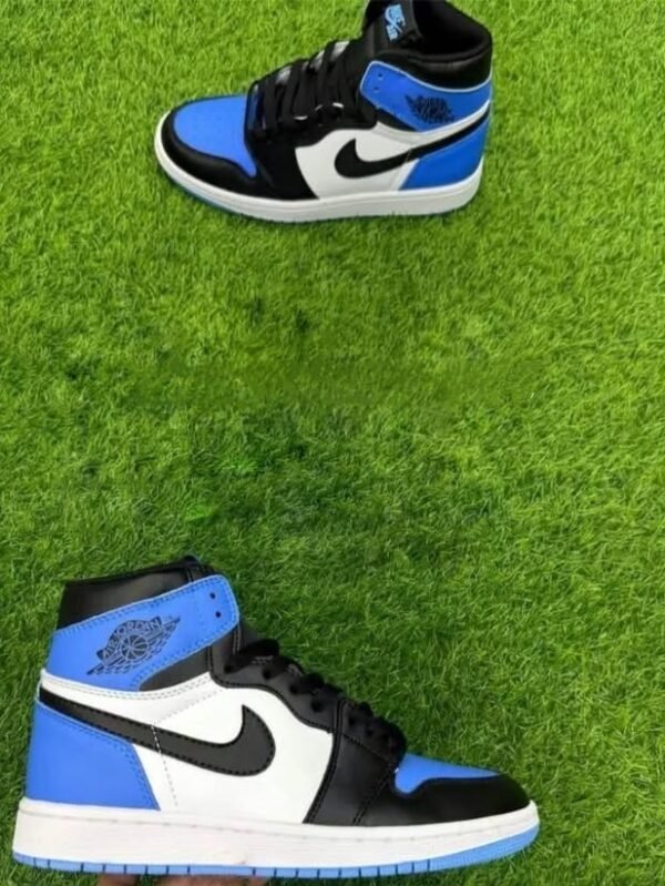 Two pairs of Nike Air Jordan 1 Mid sneakers in black, white, and royal blue displayed on fresh green grass.