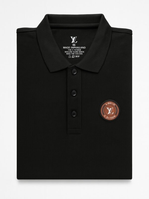 Black short-sleeve polo shirt with brown embroidered circular badge and a three-button placket.