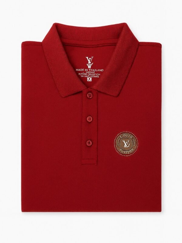 Maroon polo shirt with three-button placket and embroidered circular logo patch on the chest.