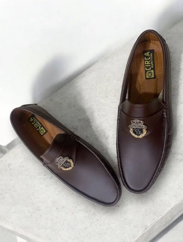 Dark brown leather loafers with crest emblem by RIRTA
