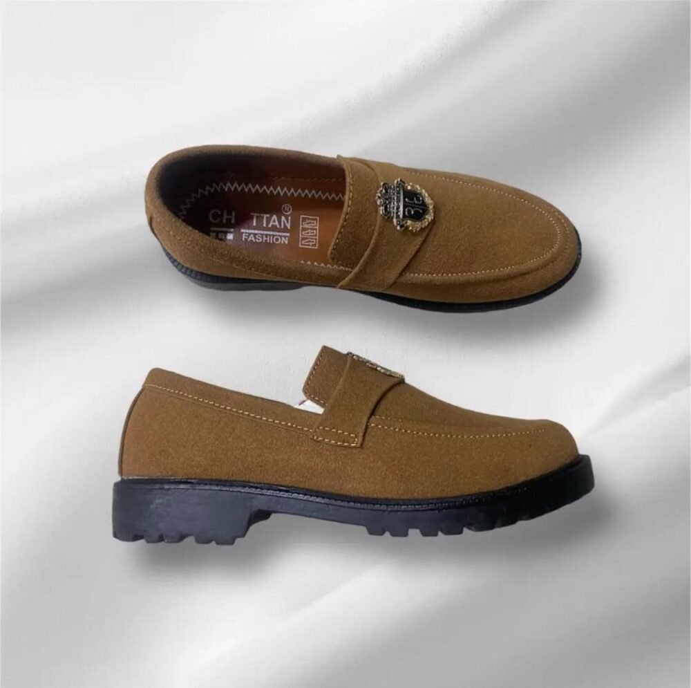 Men’s camel brown suede loafers with decorative metallic emblem and black sole