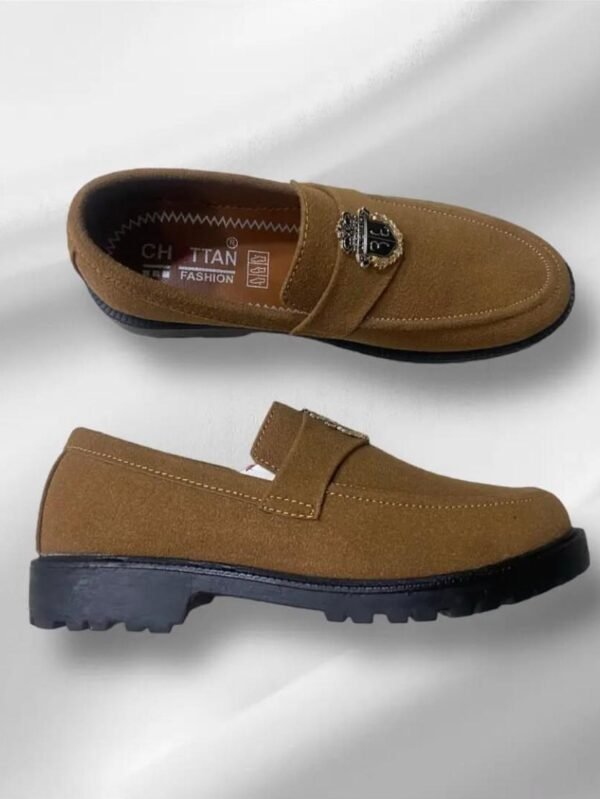 Men’s camel brown suede loafers with decorative metallic emblem and black sole